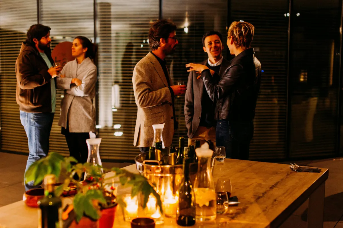Professionals talking at an evening networking gathering